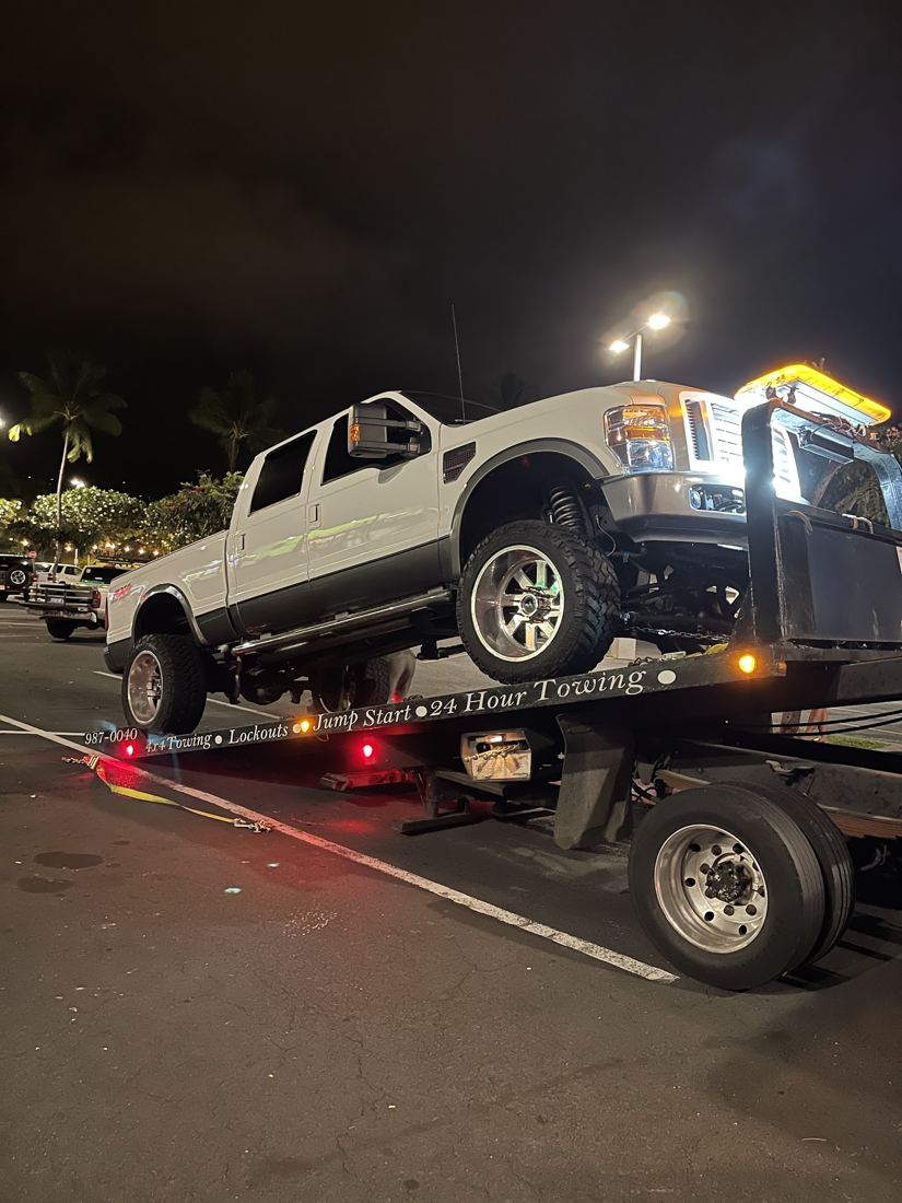 Night tow of a white pickup